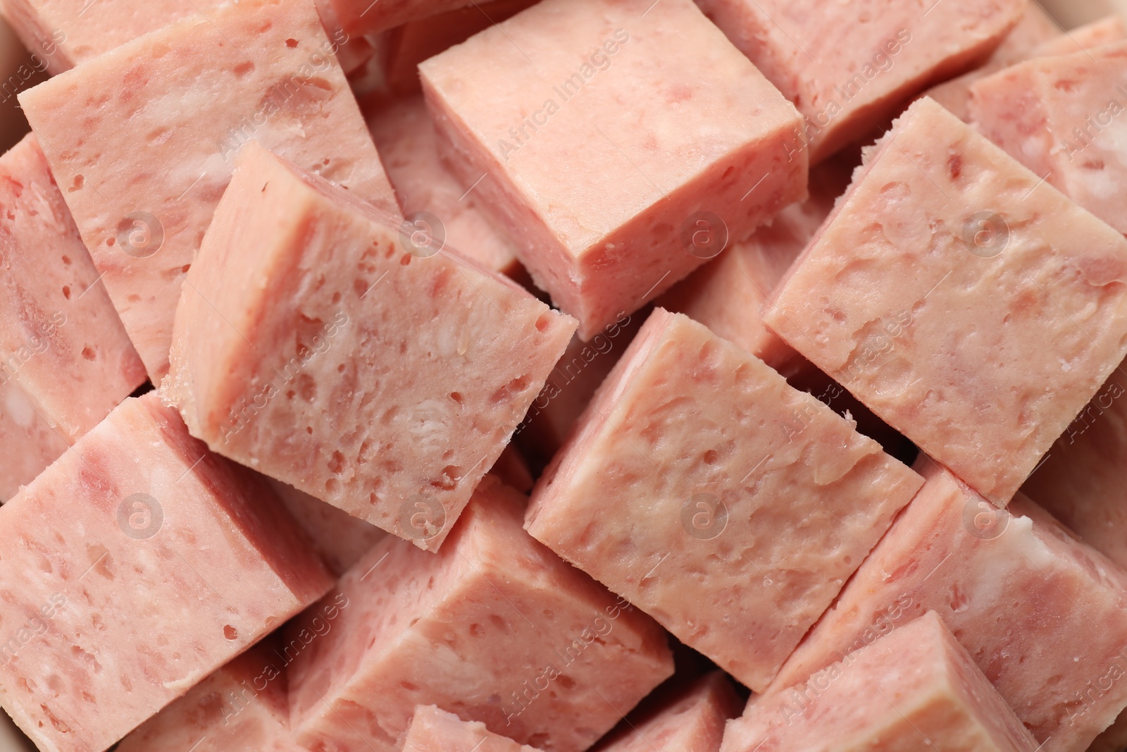 Photo of Pieces of canned meat as background, closeup