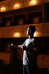 Photo of Professional actor rehearsing on stage in theatre