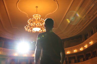 Photo of Professional actor rehearsing on stage in theatre, low angle view