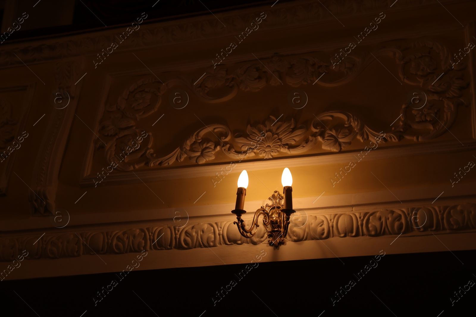 Photo of Vintage lamps on wall in theatre, low angle view