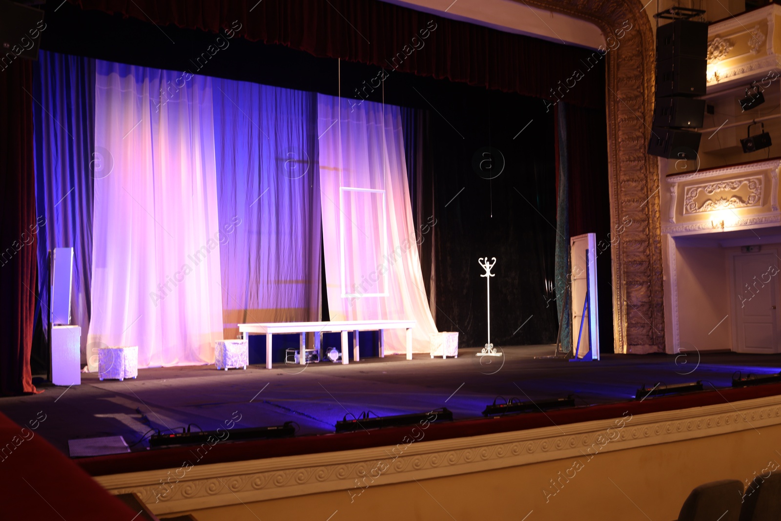 Photo of Different furniture and other decorations on stage in theatre