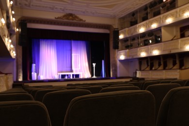 Photo of Stage and rows of comfortable seats, selective focus