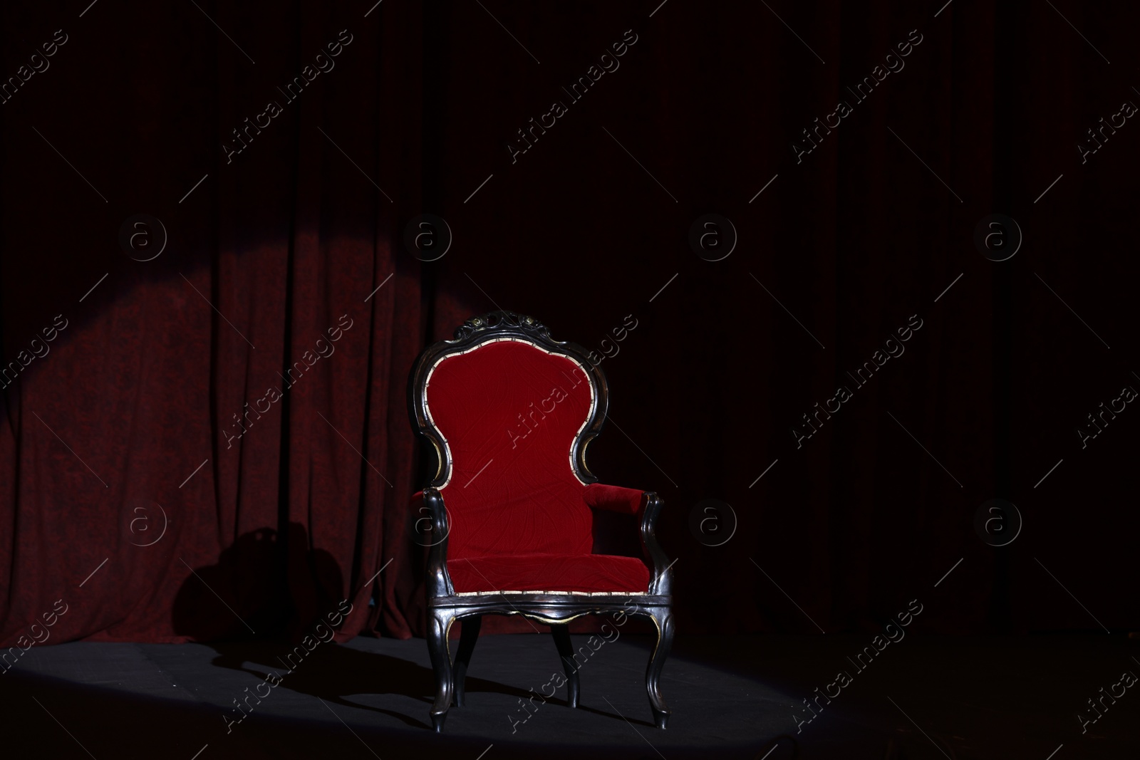 Photo of Vintage red armchair on stage in theatre