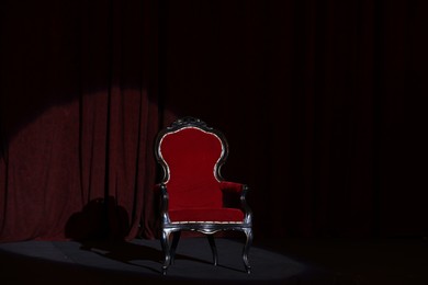 Photo of Vintage red armchair on stage in theatre