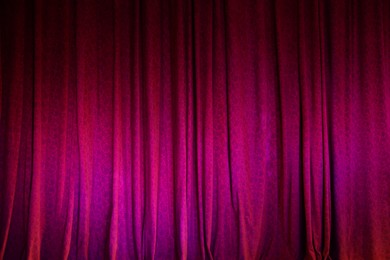 Photo of Elegant bright curtains in theatre as background, closeup