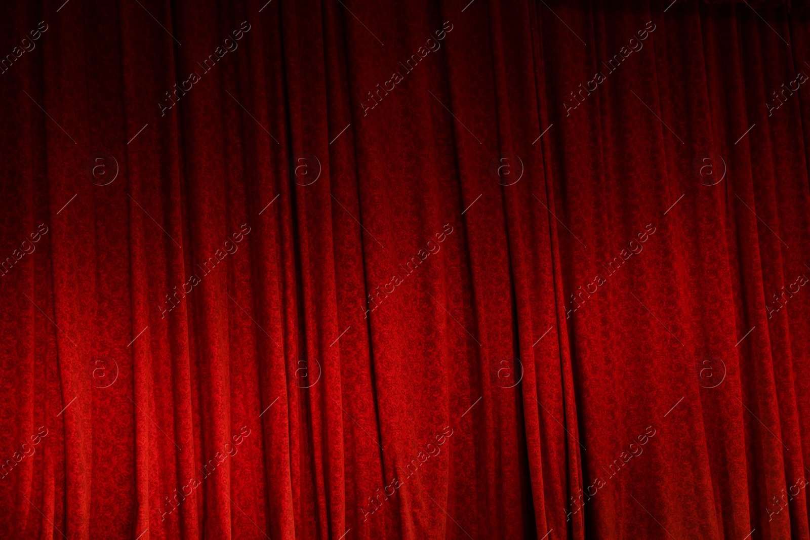 Photo of Elegant red curtains in theatre as background, closeup