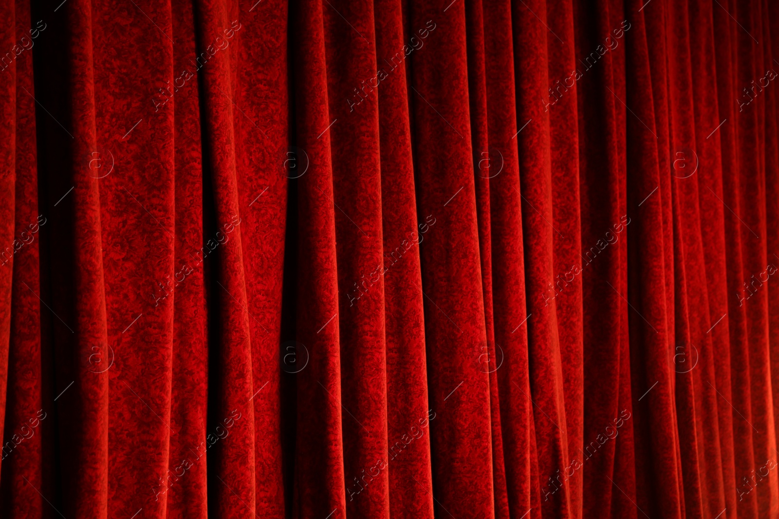 Photo of Elegant red curtains in theatre as background, closeup