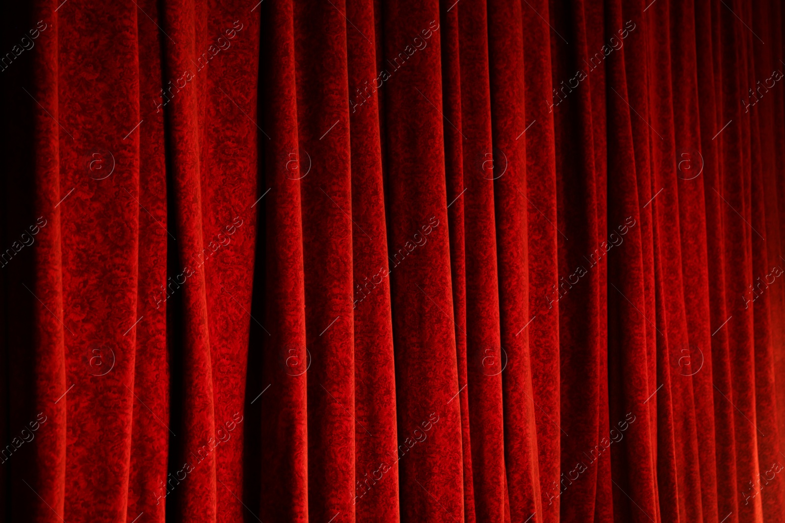 Photo of Elegant red curtains in theatre as background, closeup