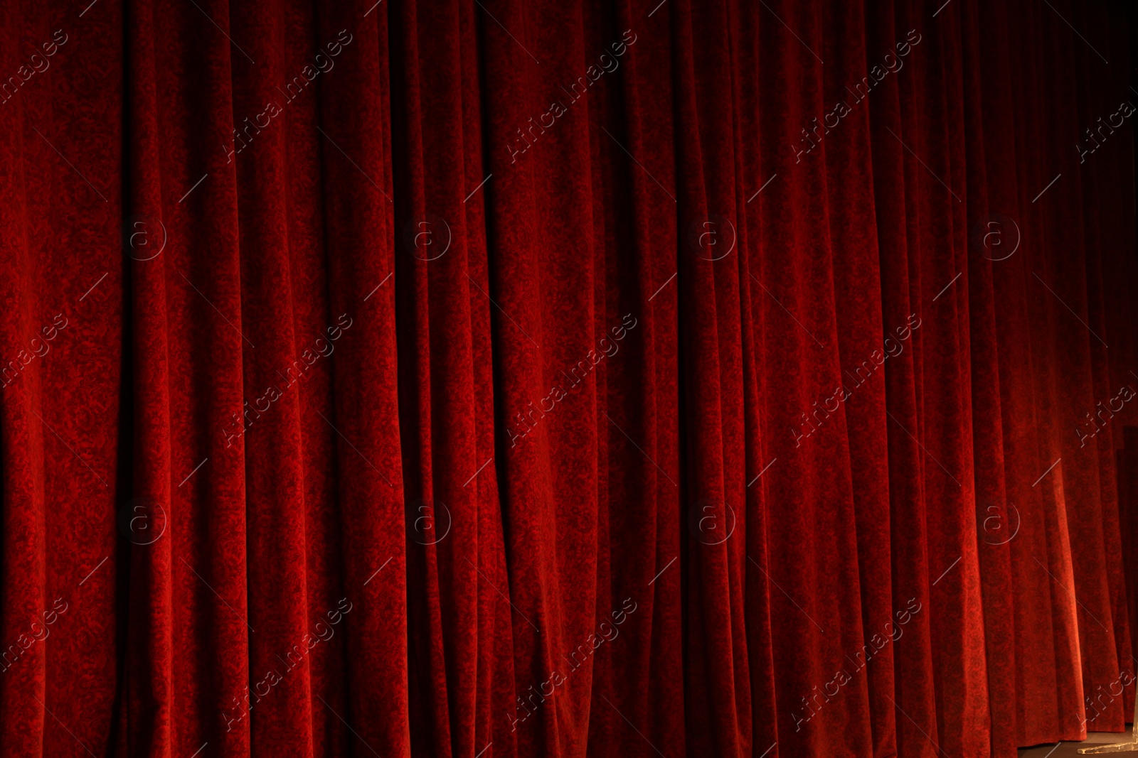 Photo of Elegant red curtains in theatre as background, closeup