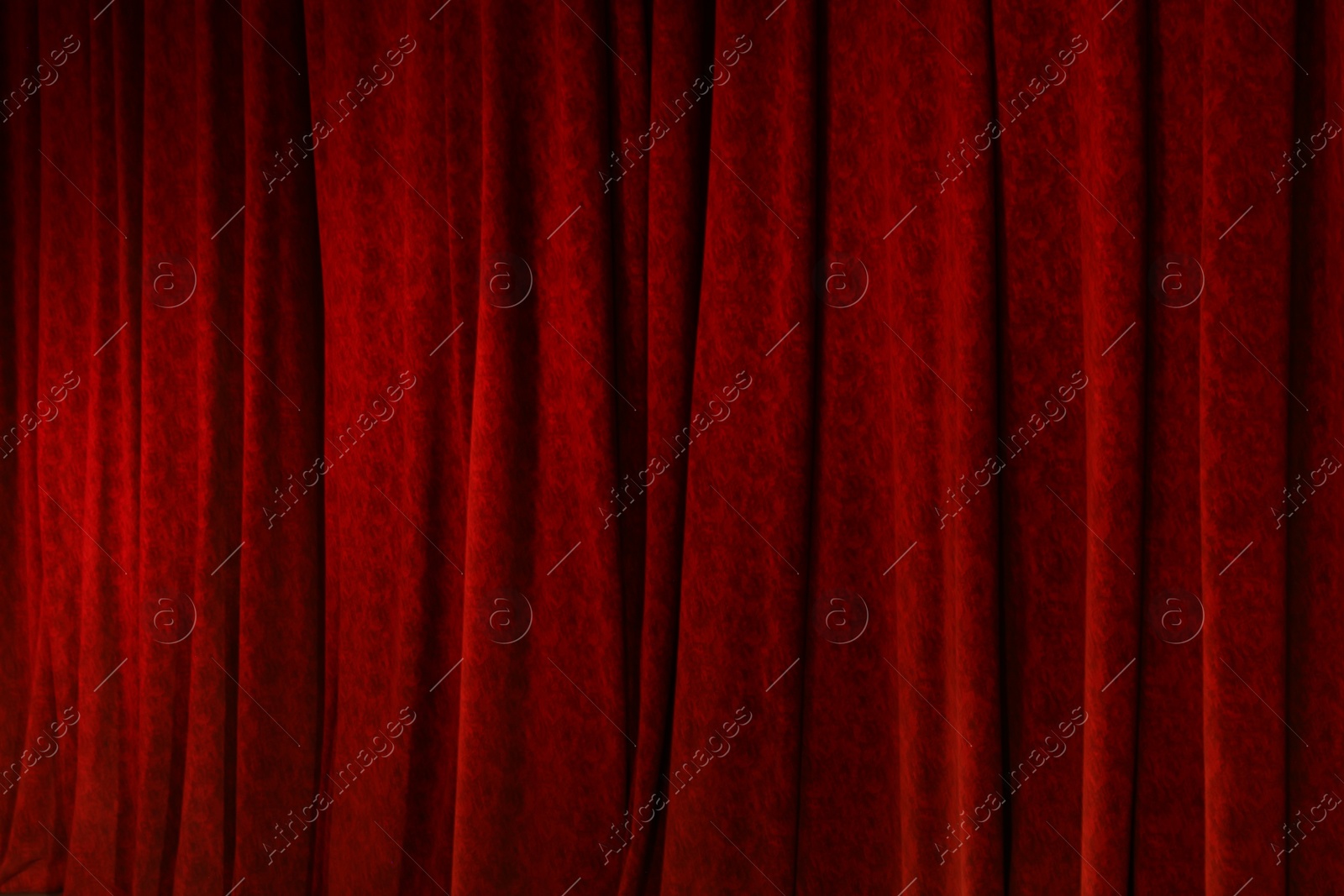 Photo of Elegant red curtains in theatre as background, closeup