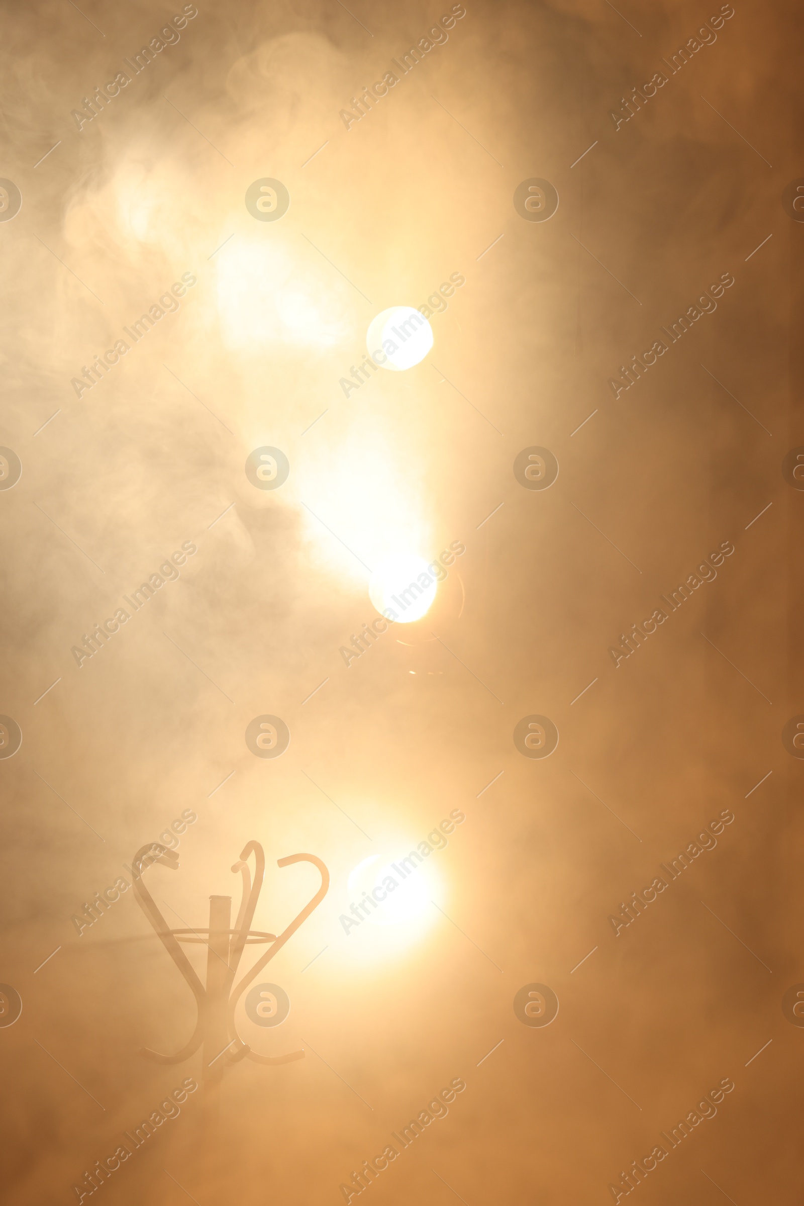 Photo of Professional spotlights and smoke on stage in theatre