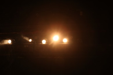 Photo of Bright professional spotlights on stage in theatre