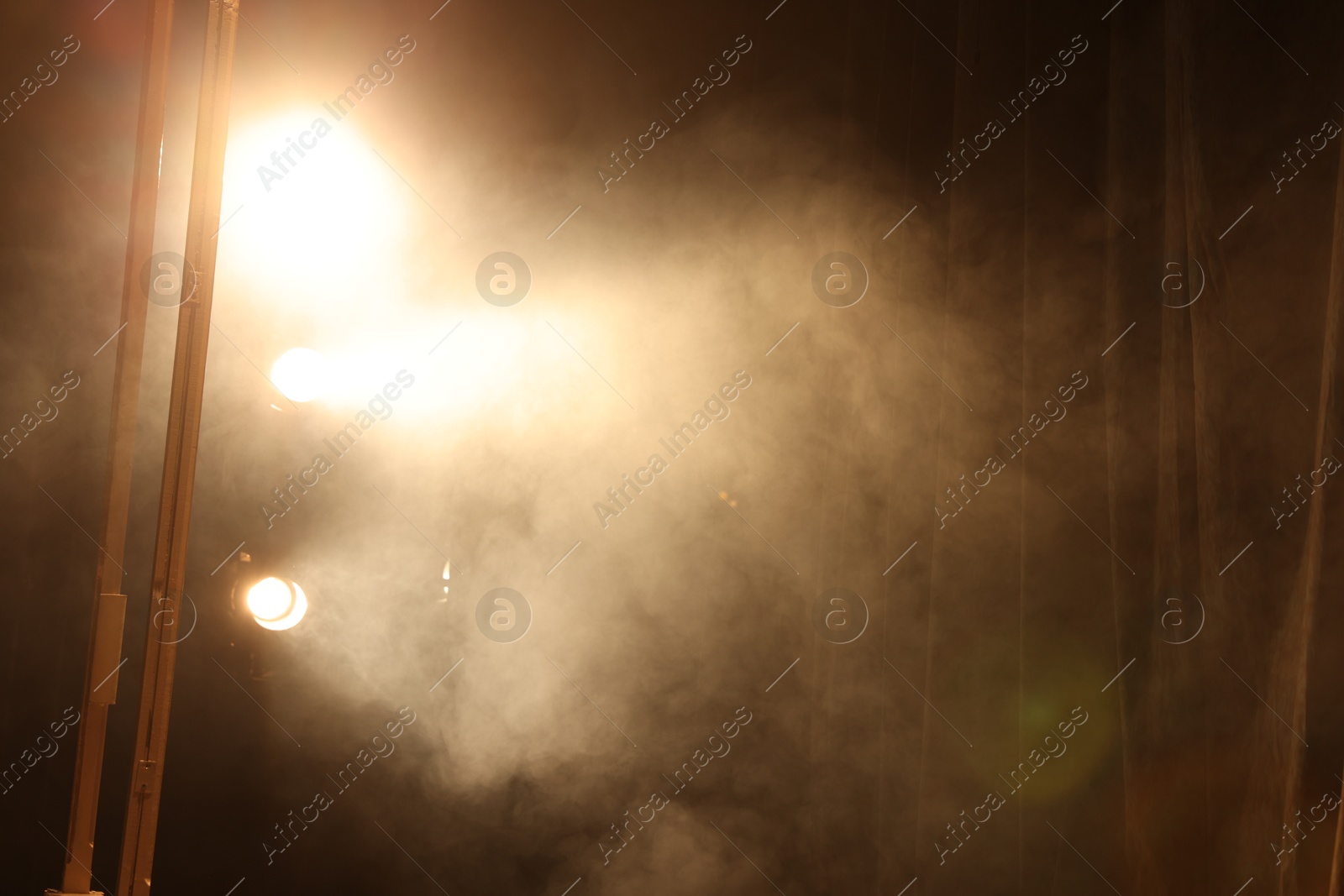 Photo of Professional spotlights and smoke on stage in theatre