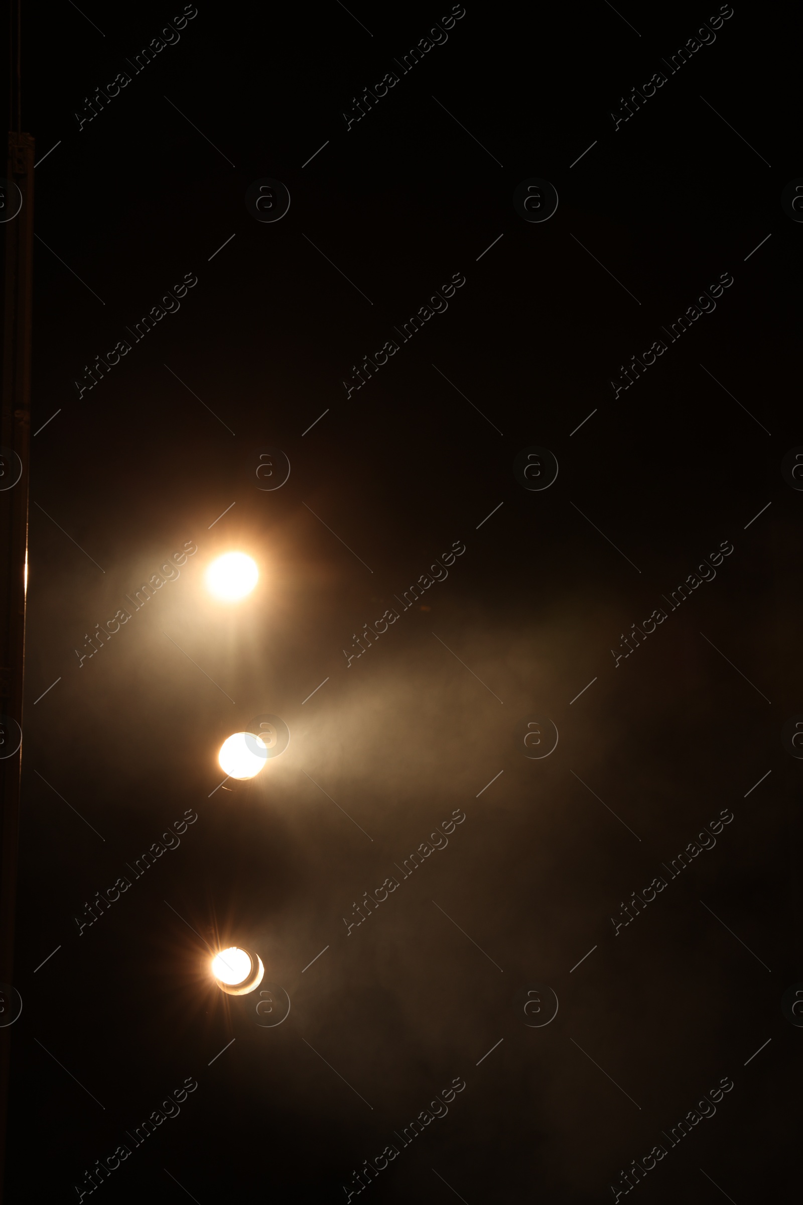 Photo of Professional spotlights and smoke on stage in theatre