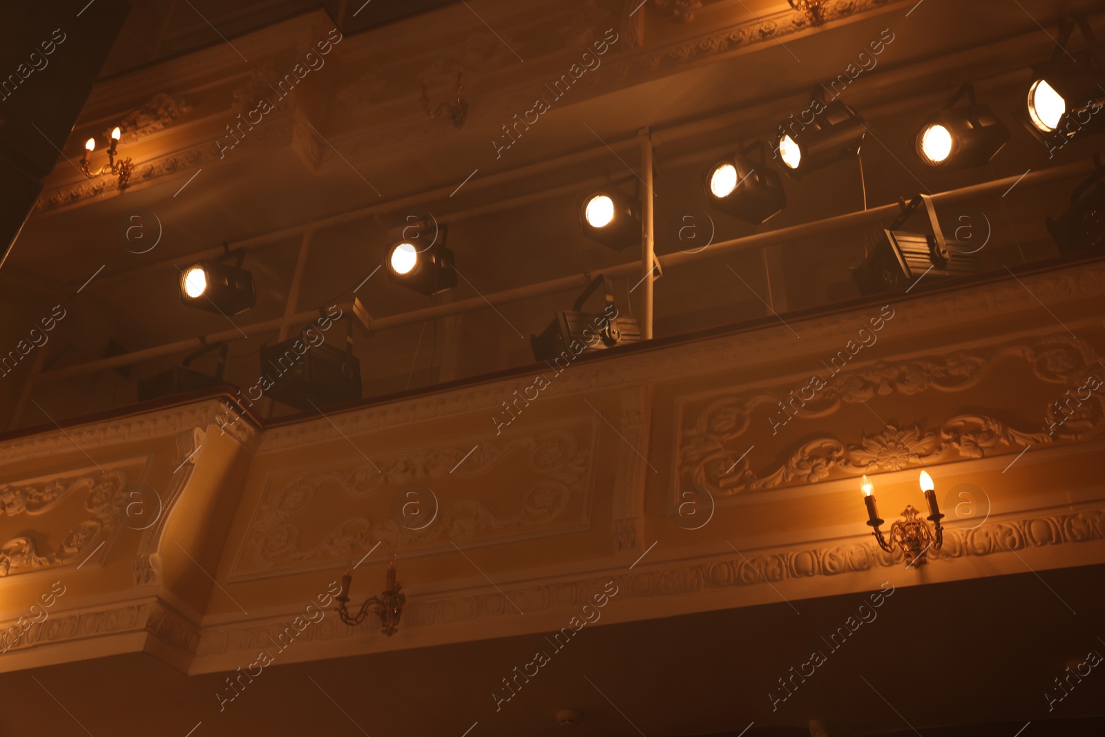 Photo of Professional spotlights and smoke in theatre, low angle view