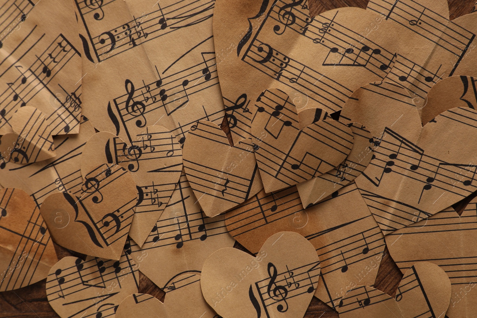 Photo of Paper hearts with notes on wooden table, flat lay