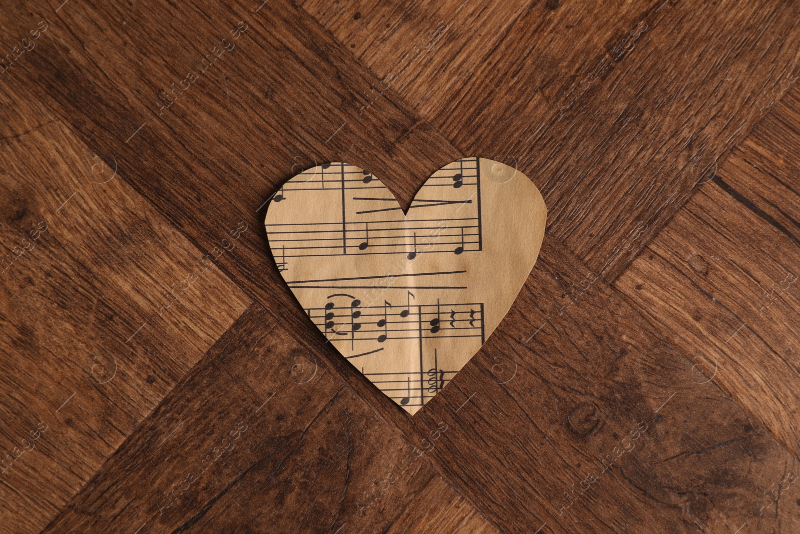 Photo of Paper heart with notes on wooden table, top view