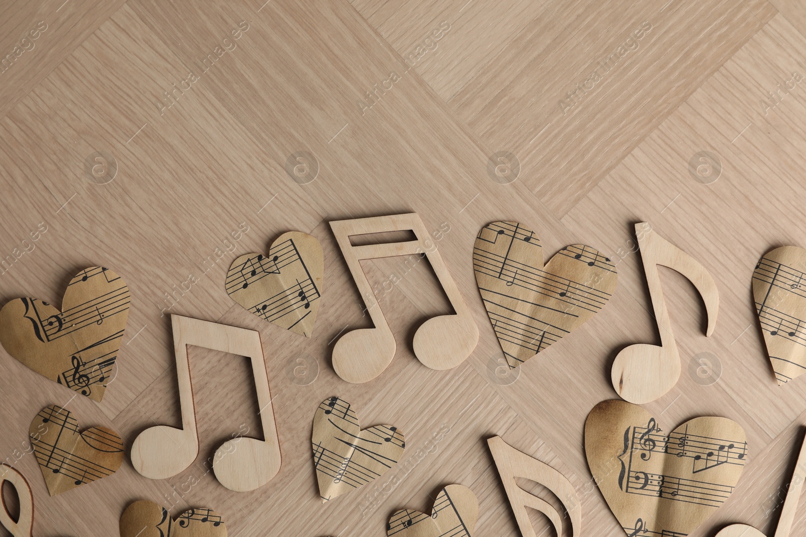 Photo of Paper hearts and notes on wooden table, flat lay. Space for text