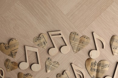 Photo of Paper hearts and notes on wooden table, flat lay. Space for text