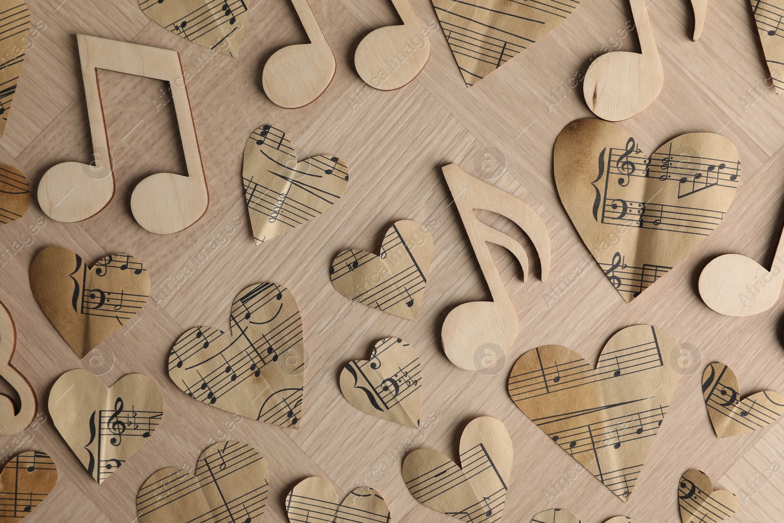 Photo of Paper hearts and notes on wooden table, flat lay