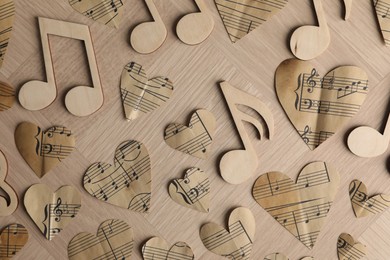 Photo of Paper hearts and notes on wooden table, flat lay