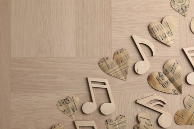 Photo of Paper hearts and notes on wooden table, flat lay. Space for text