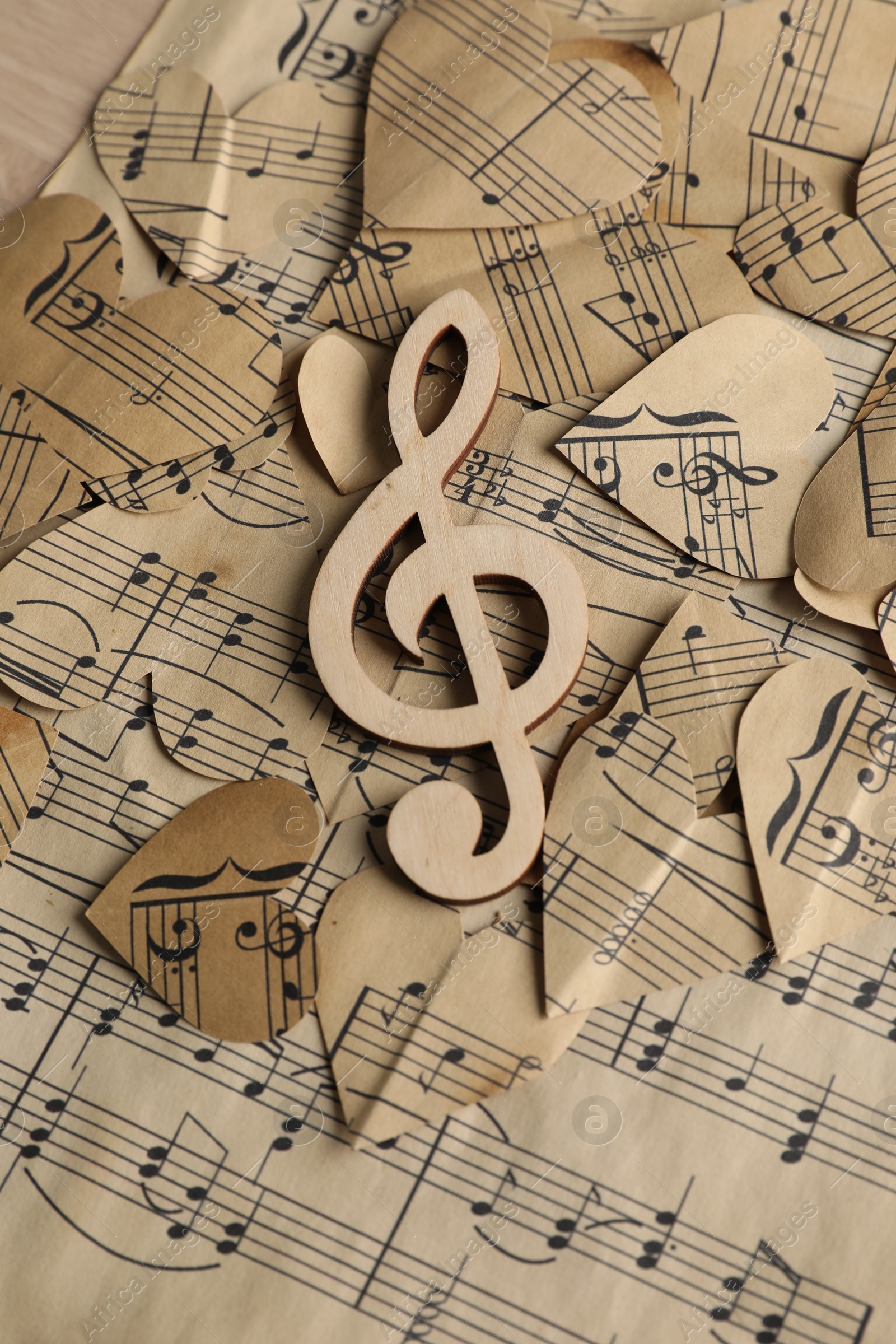 Photo of Clef note and paper hearts with notes on table, top view