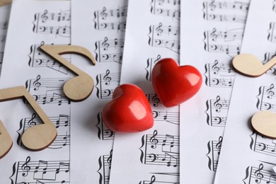 Photo of Hearts and notes on musical note sheets, closeup