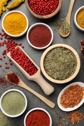 Photo of Different aromatic spices on grey table, flat lay