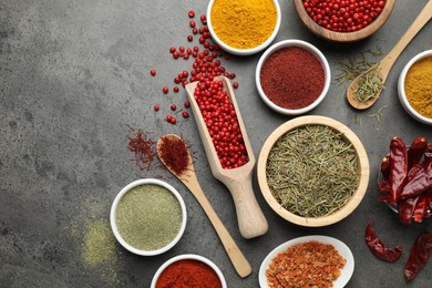 Photo of Different aromatic spices on grey table, flat lay