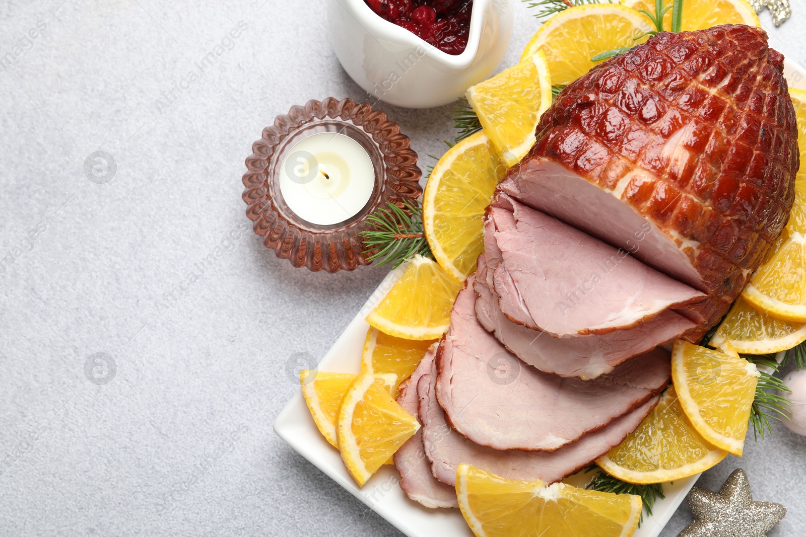 Photo of Tasty baked ham served on white table, flat lay. Space for text