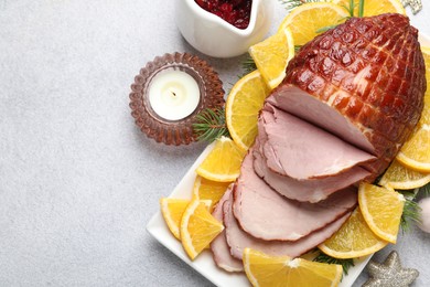 Tasty baked ham served on white table, flat lay. Space for text