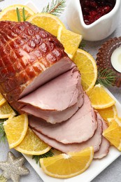 Photo of Tasty baked ham served on white table, flat lay