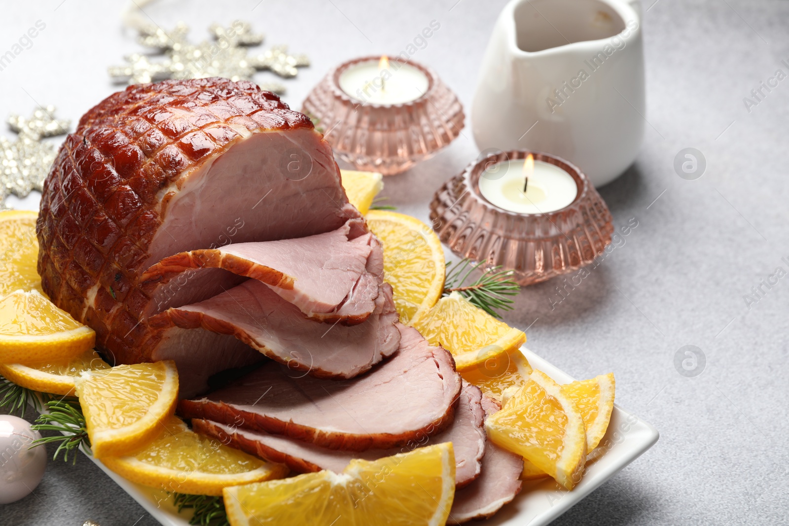 Photo of Tasty baked ham served on white table, closeup