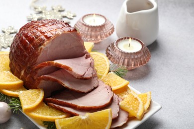 Tasty baked ham served on white table, closeup