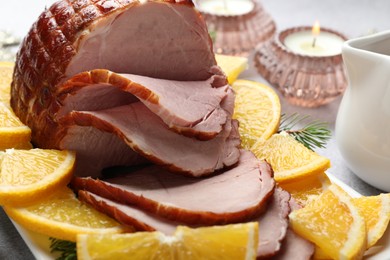 Tasty baked ham served on white table, closeup