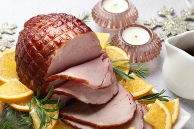 Tasty baked ham served on white table, closeup