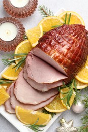 Tasty baked ham served on white table, flat lay