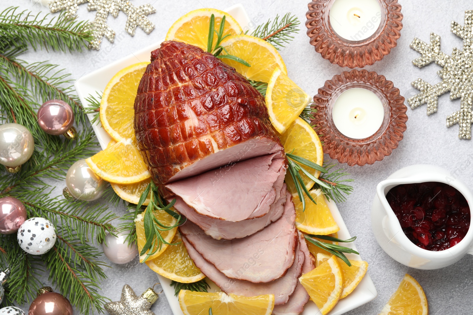 Photo of Tasty baked ham served on white table, flat lay