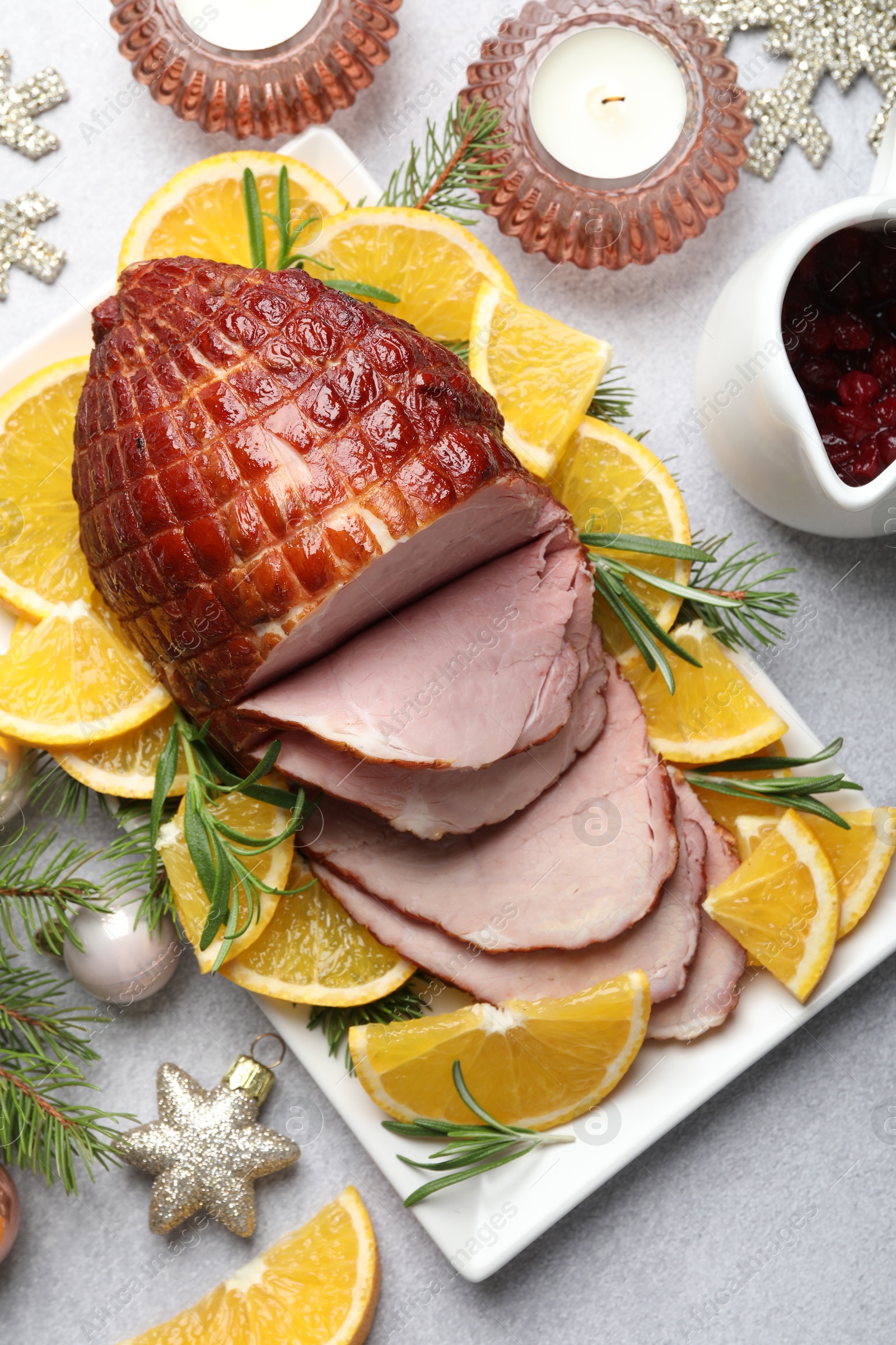 Photo of Tasty baked ham served on white table, flat lay