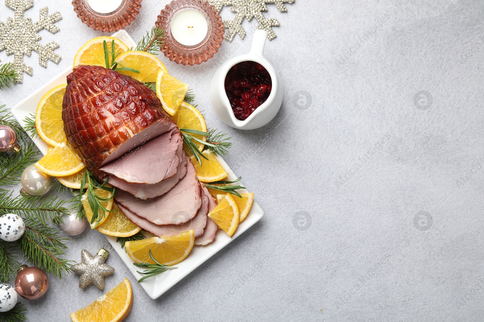 Photo of Tasty baked ham served on white table, flat lay. Space for text