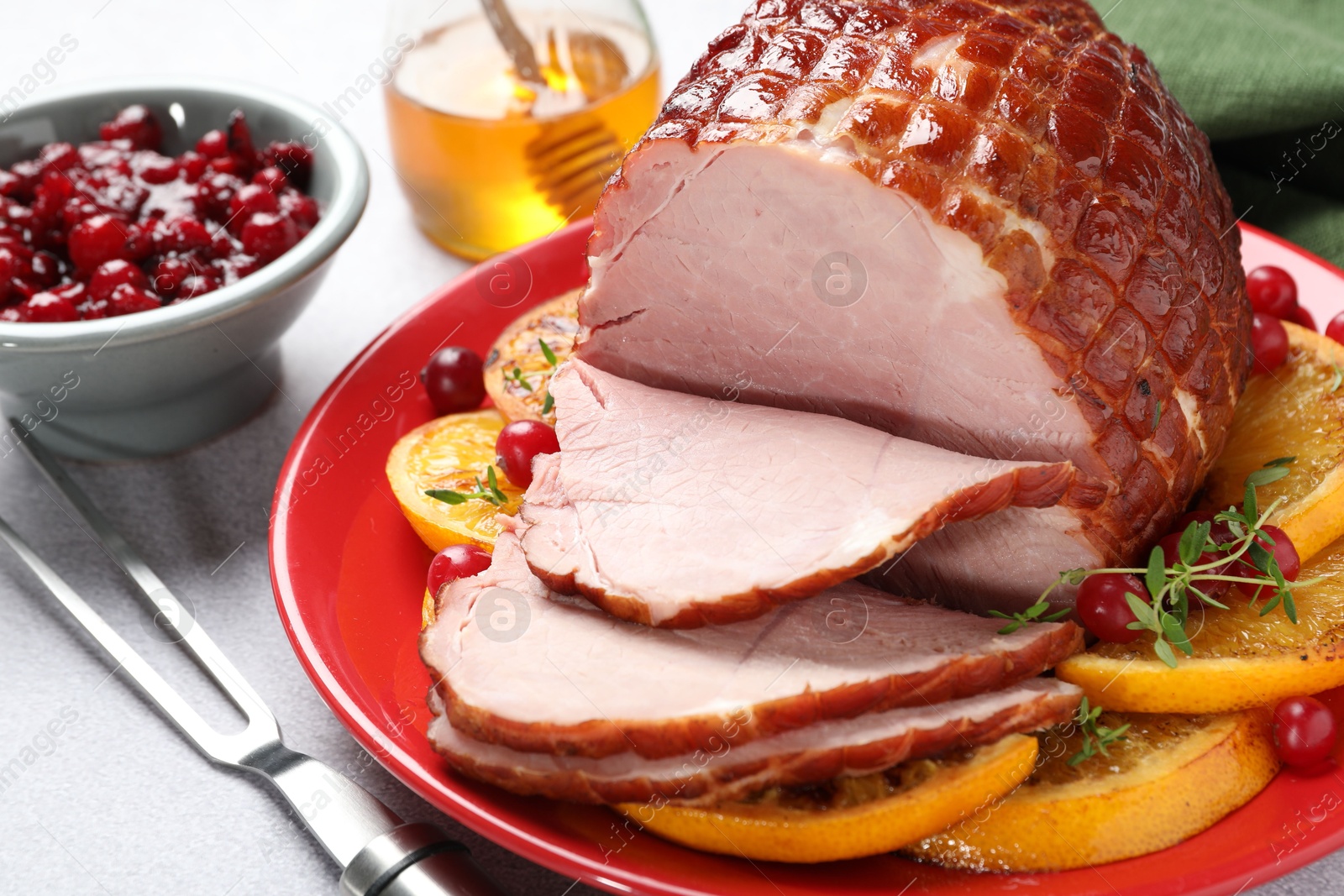 Photo of Tasty baked ham served on white table, closeup