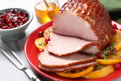 Photo of Tasty baked ham served on white table, closeup