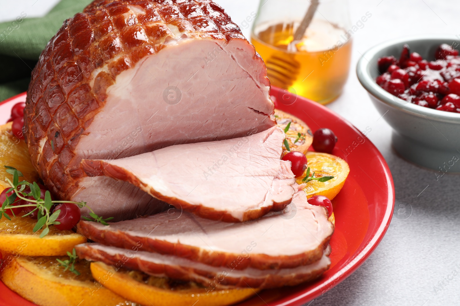 Photo of Tasty baked ham served on white table, closeup