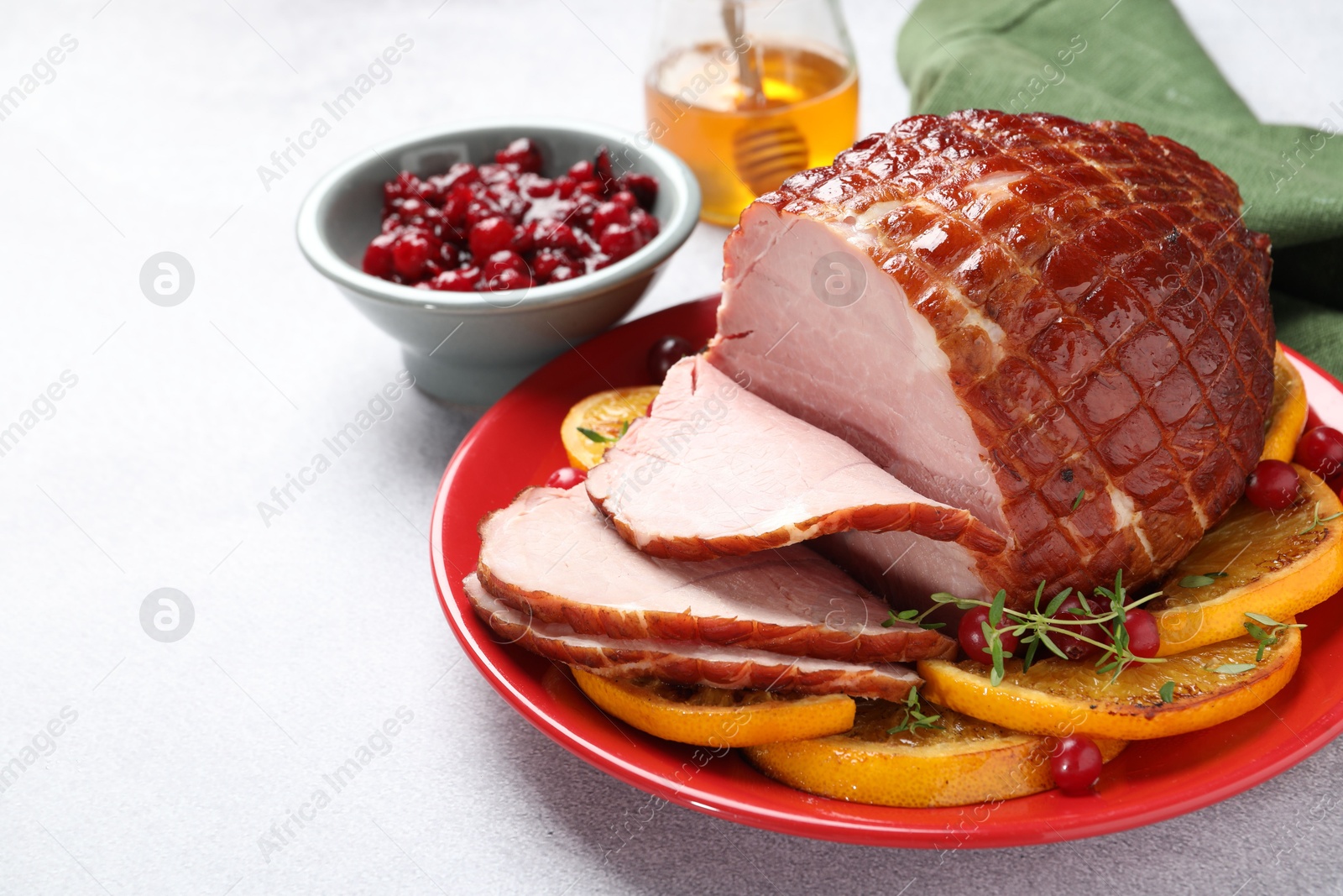 Photo of Tasty baked ham served on white table, space for text