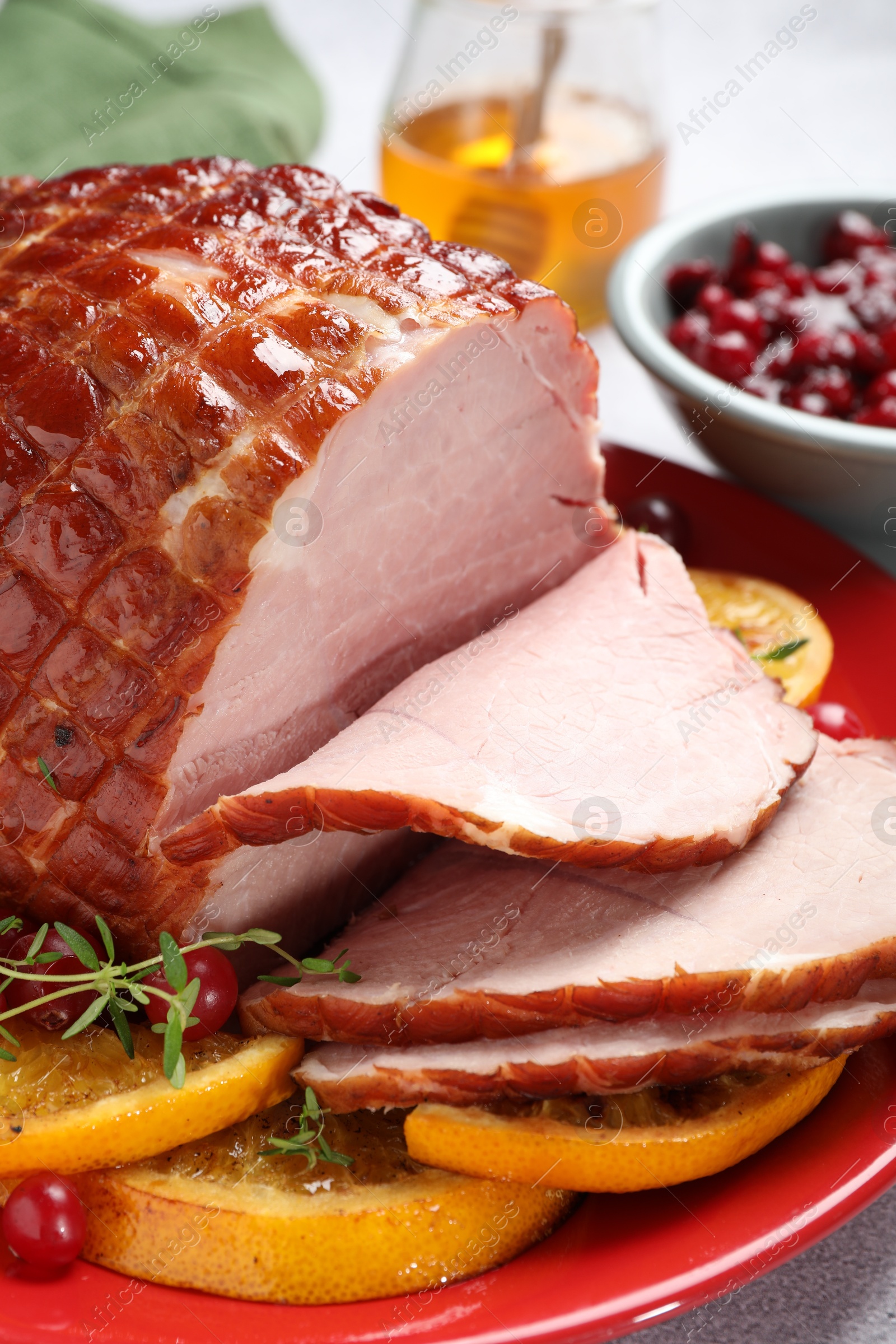 Photo of Tasty baked ham served on white table, closeup