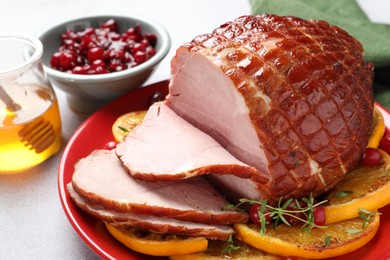 Photo of Tasty baked ham served on white table, closeup