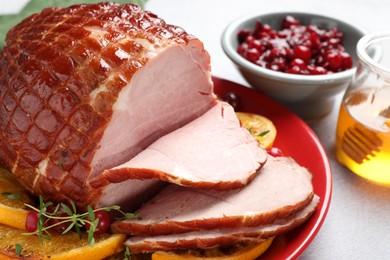 Photo of Tasty baked ham served on white table, closeup