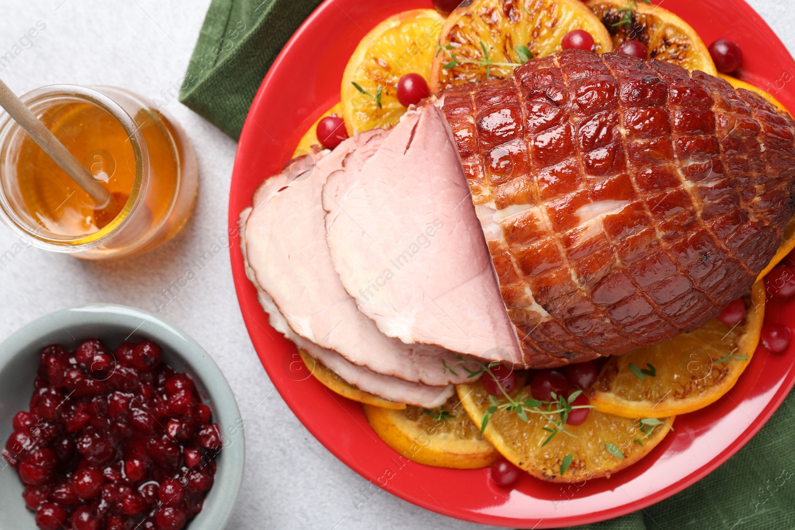 Photo of Tasty baked ham served on white table, flat lay