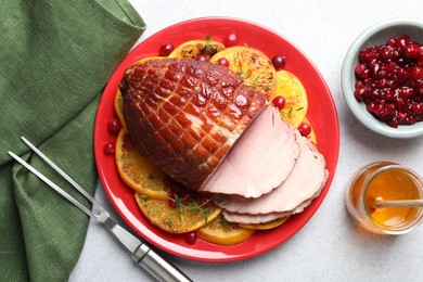 Photo of Tasty baked ham served on white table, flat lay